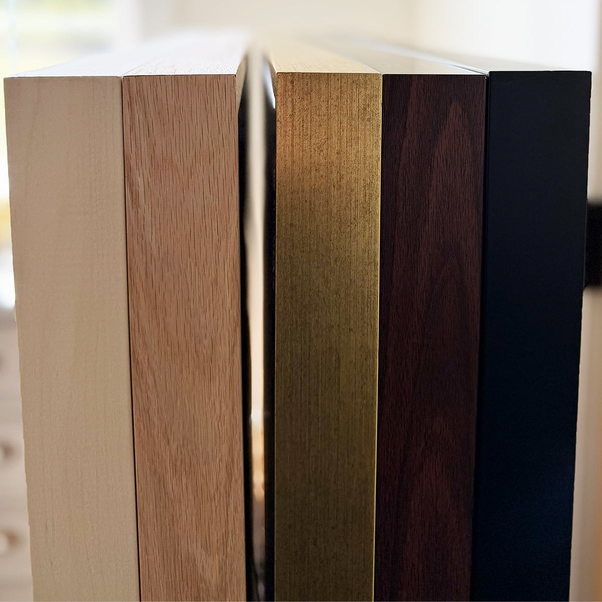 a collection of wooden blocks or planks, each with a different color and texture, arranged in a row.