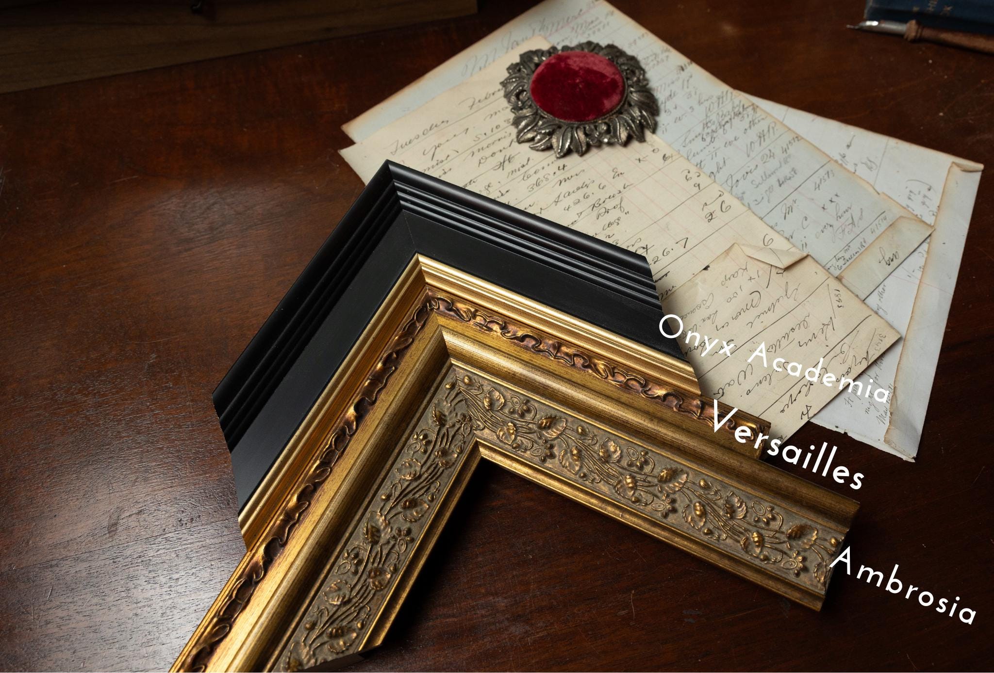 a wooden table topped with framed pictures and papers