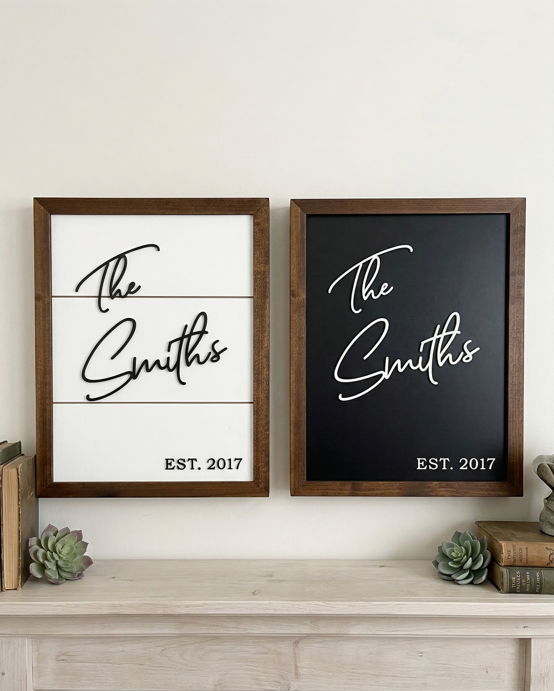 Two framed concealment boxes with 'The Smiths' and 'EST. 2017' on a wooden surface.