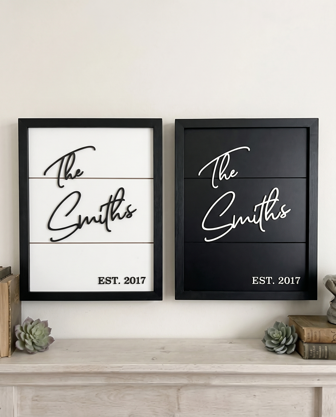 Two framed concealment boxes with 'The Smiths' and 'EST. 2017' on a wooden surface.