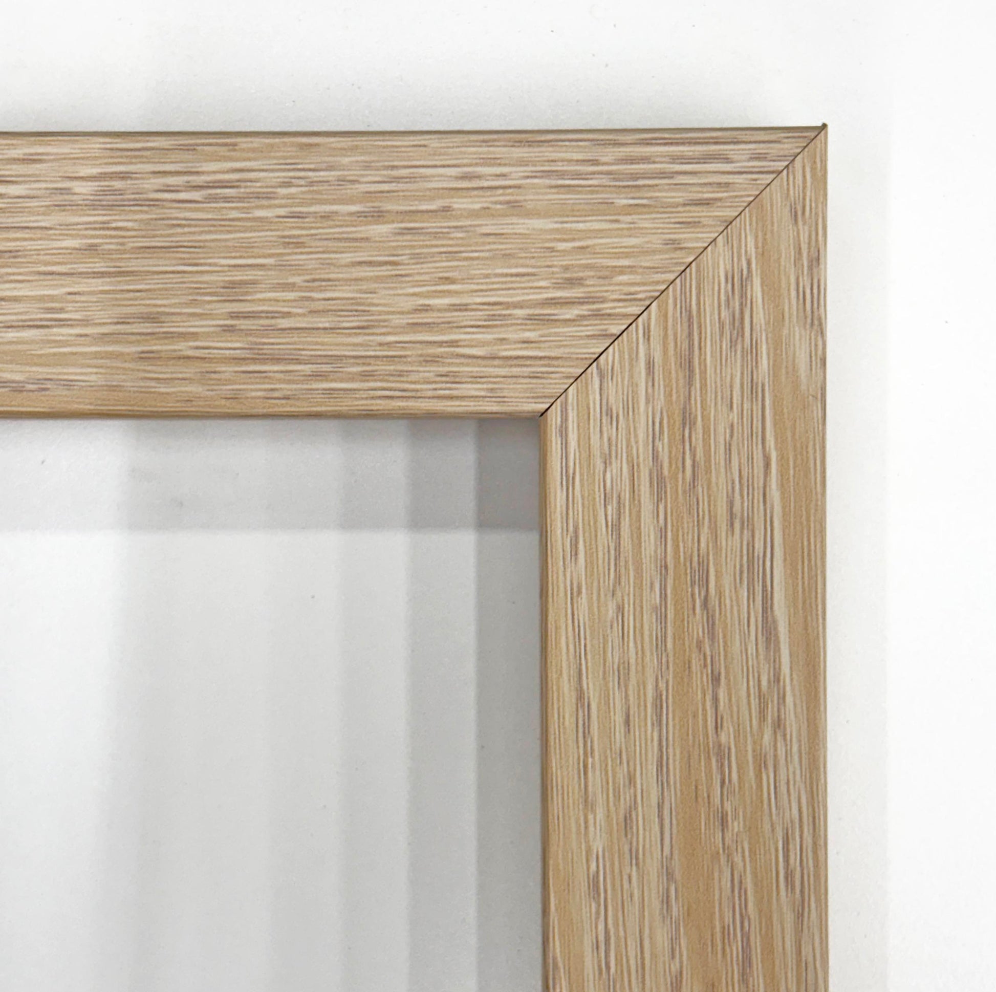 a close-up view of a wooden frame with a light-colored wood grain texture.