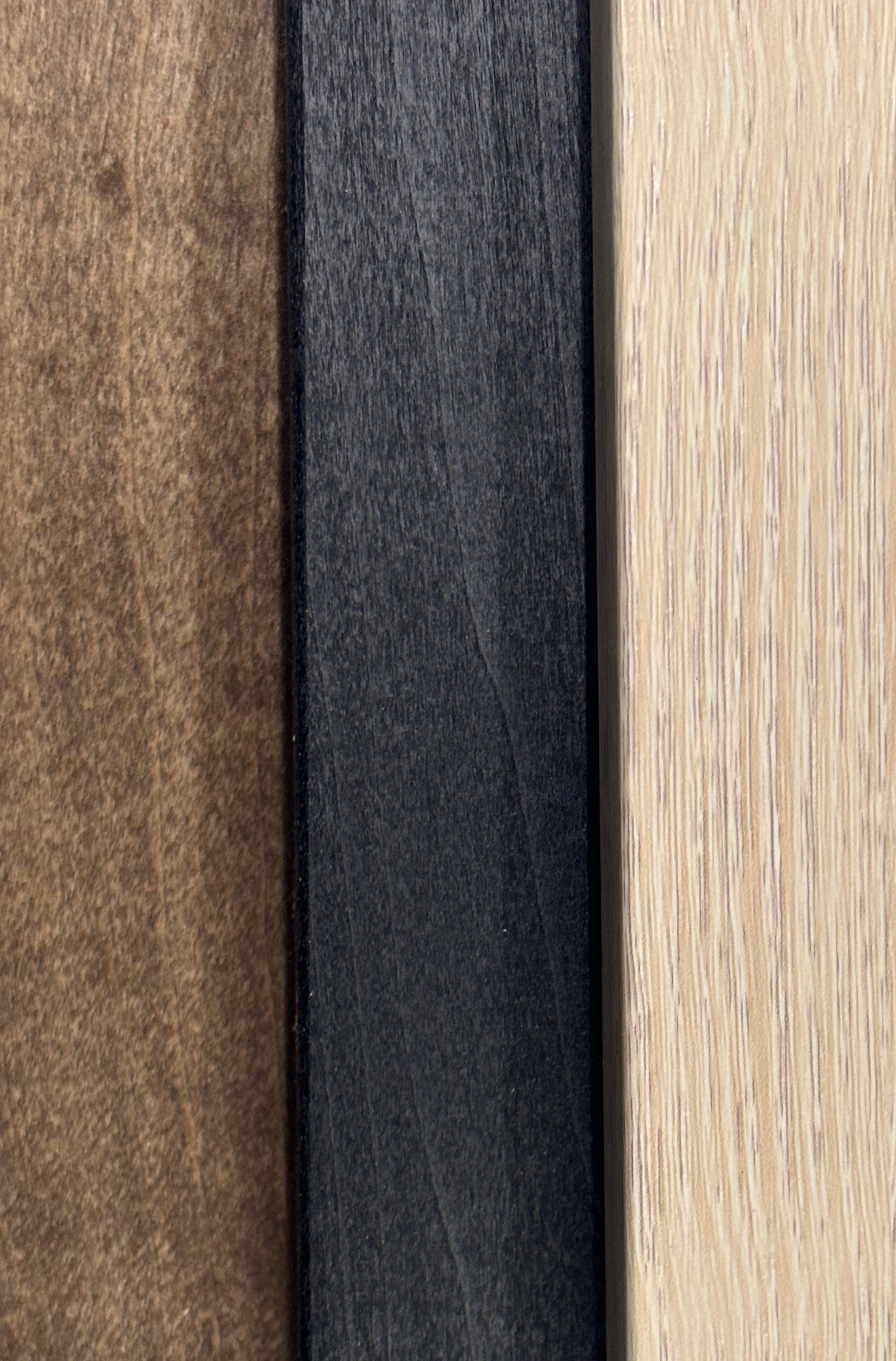 three distinct wood grain textures: a dark brown wood grain, a black wood grain, and a light brown wood grain.