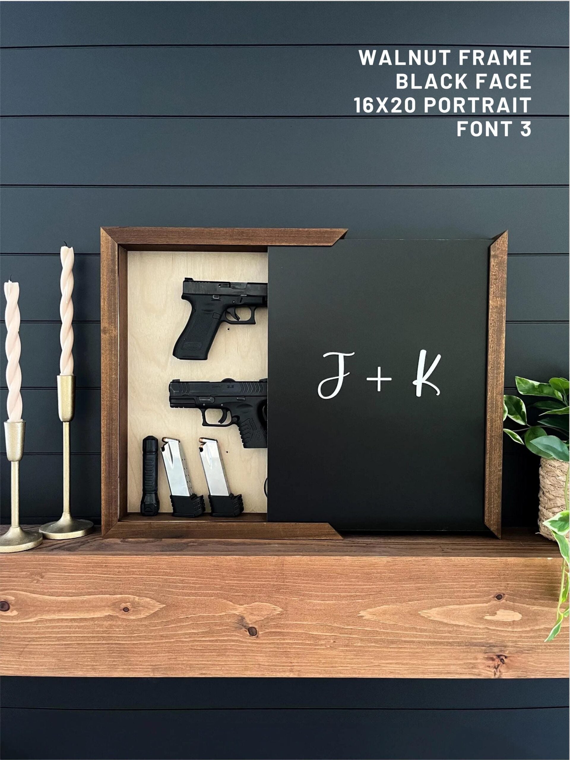 Wooden frame with guns  displaying J + K on a wooden surface.